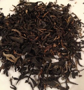 Dry, unsteeped leaves of the Hawaiian grown Aged Roasted Black Tea.